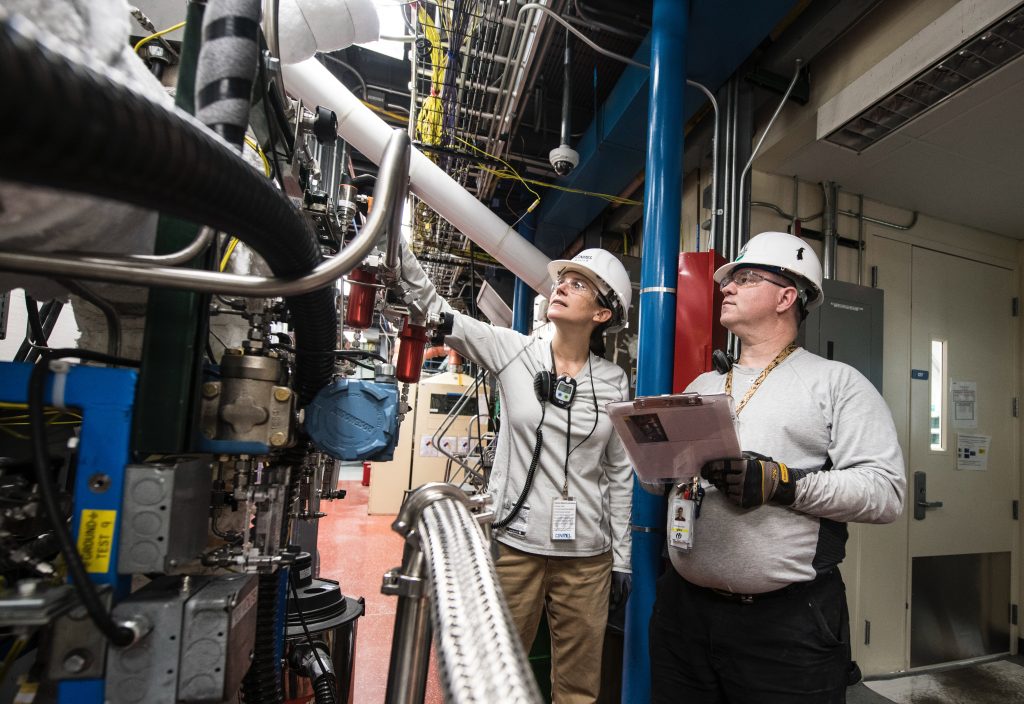 two engineers examining a machine