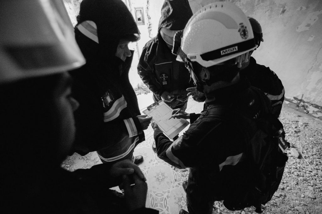 a group of workers gathered and looking over a clipboard