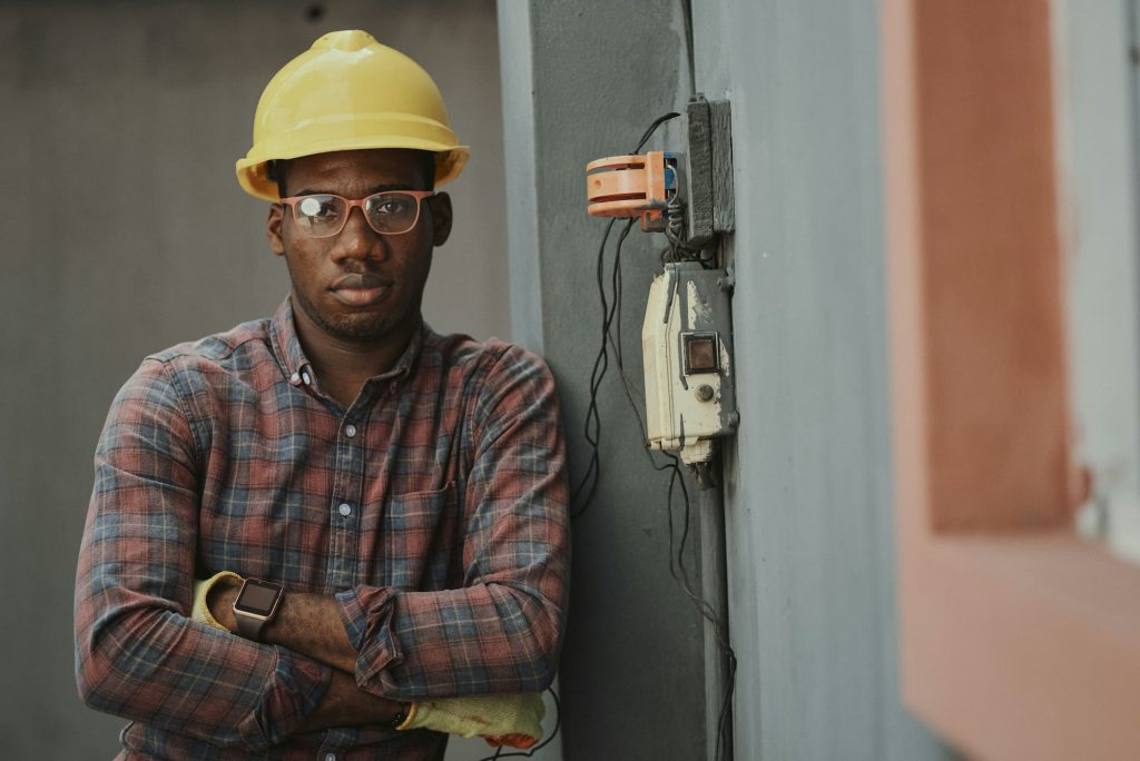 Portrait of a manufacturer at a building site wearing a hard hat and eye goggles
