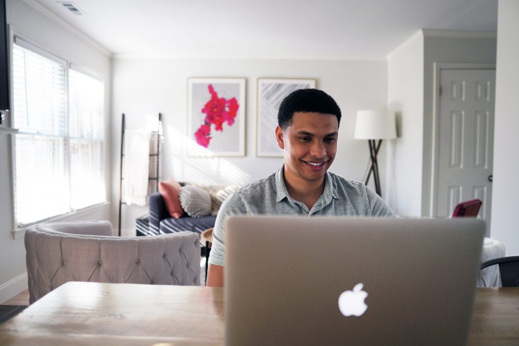 a man sitting at a computer, doing work