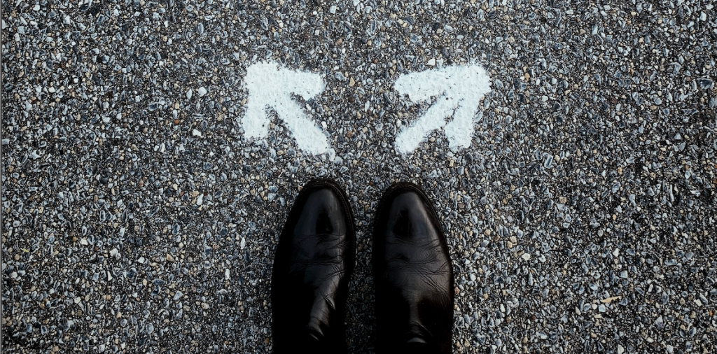 a pair of shoes in front of two arrows pointing in different directions