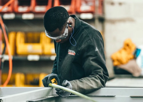 a young worker holding a measuring tape