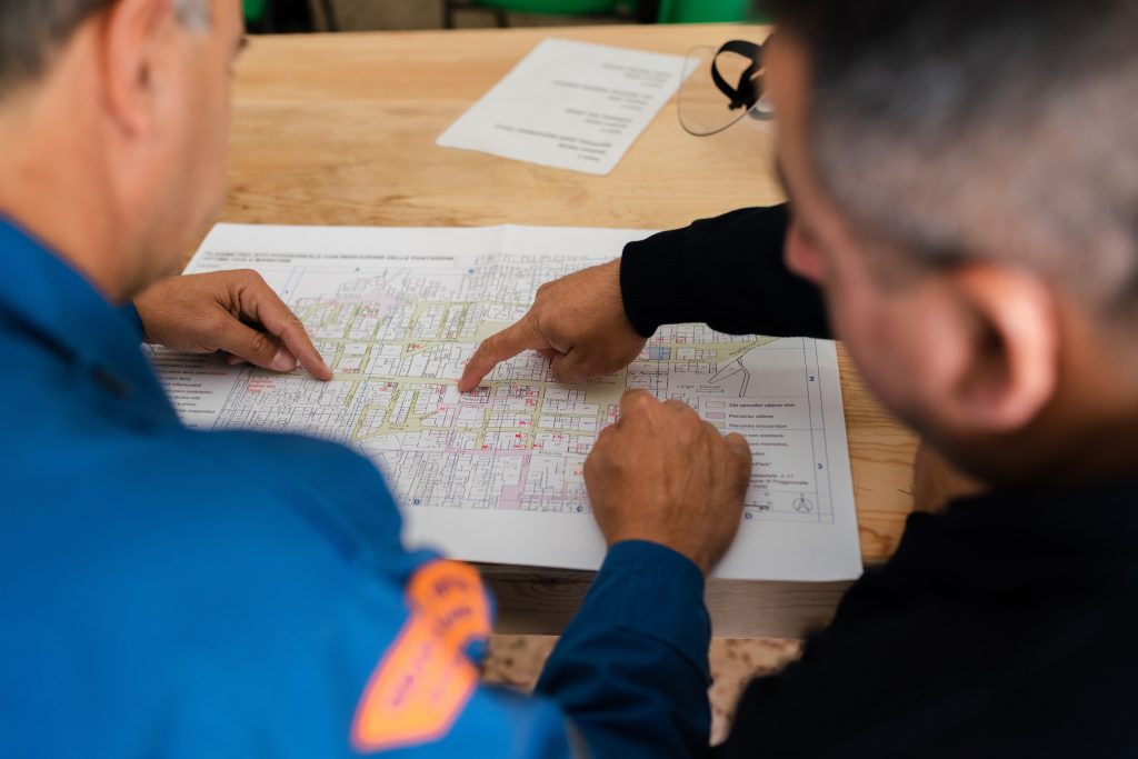 two people pointing at a chart