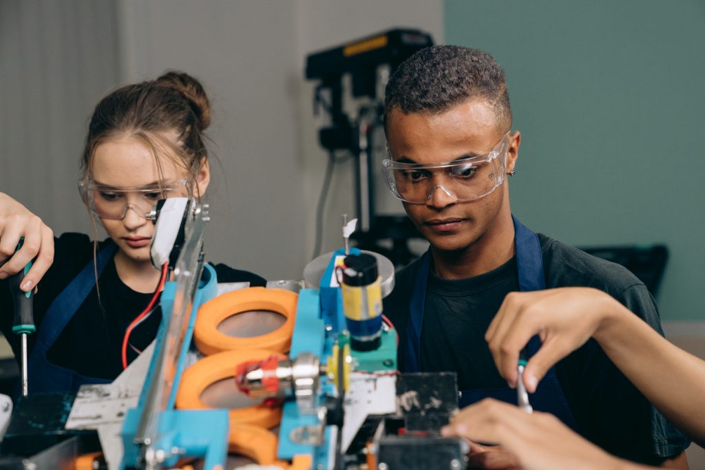 two people working on machinery