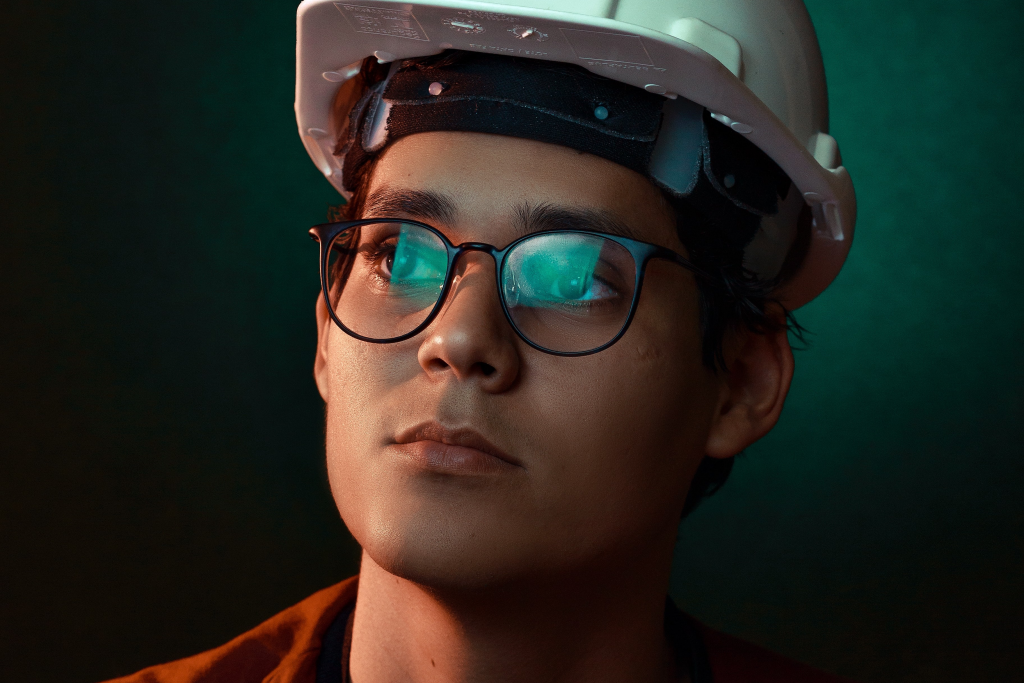 a person wearing a hardhat and glasses