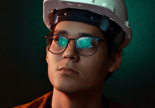 a person wearing a hardhat and glasses