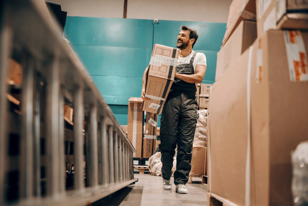 worker taking a box to a shelf