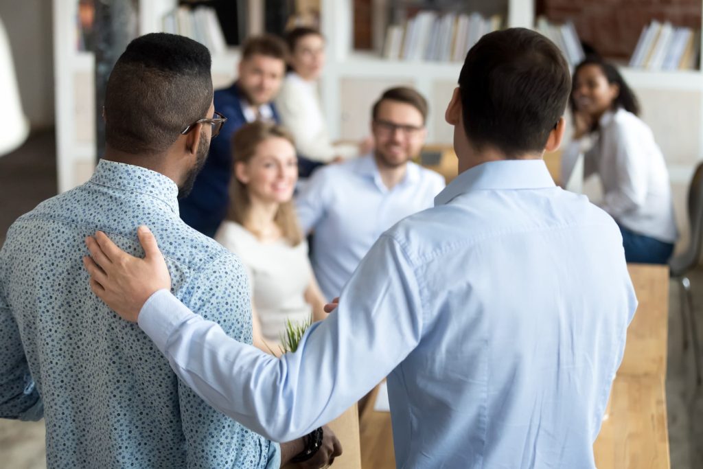 a man introducing a new worker to employees